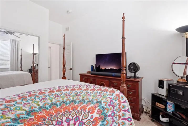 Bedroom with white walls and carpet flooring