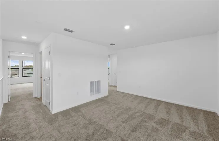 Unfurnished room featuring light carpet and recessed lighting