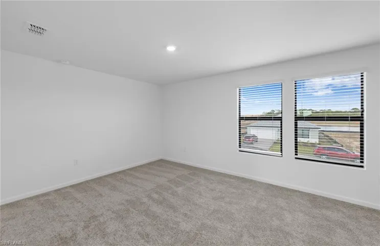 Unfurnished room with baseboards and carpet