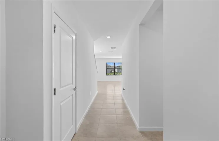 Corridor featuring recessed lighting and light tile patterned flooring