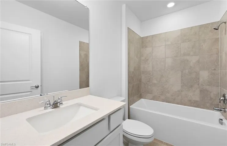Full bath featuring vanity and shower / bath combination