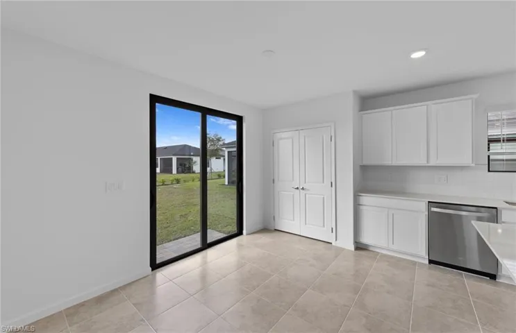 Kitchen featuring white cabinetry, dishwasher, tasteful backsplash, light tile patterned floors, and recessed lighting