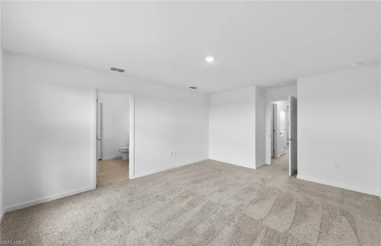 Unfurnished room with light carpet and recessed lighting