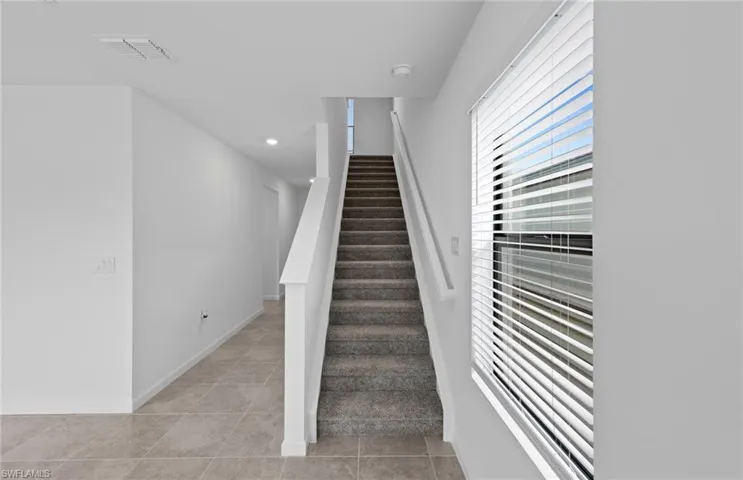 Stairway featuring baseboards and recessed lighting