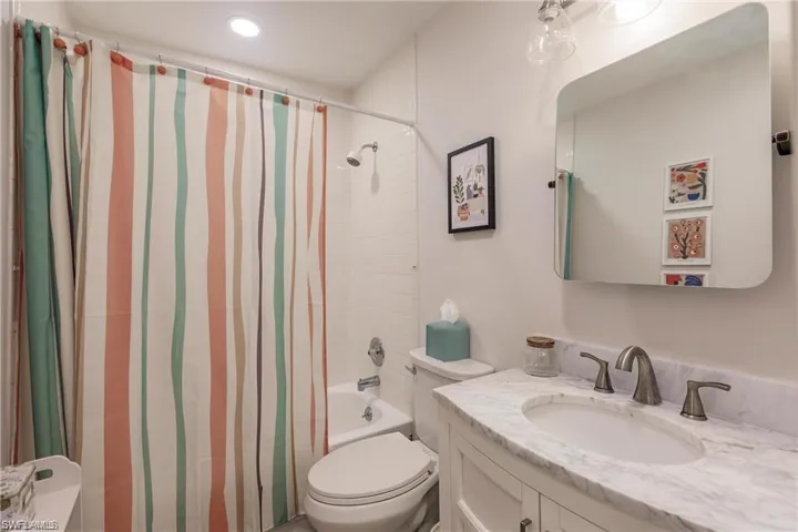 Bedroom featuring baseboards, recessed lighting, and light wood-style floors