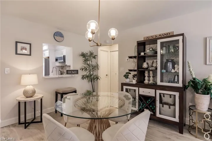 Living room featuring ceiling fan with notable chandelier, recessed lighting, wood finished floors, and visible vents