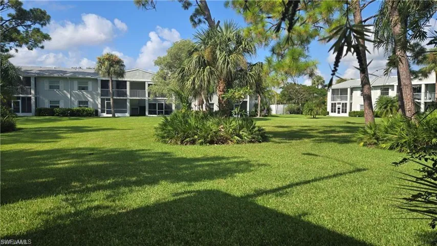 Community pool featuring a patio and fence