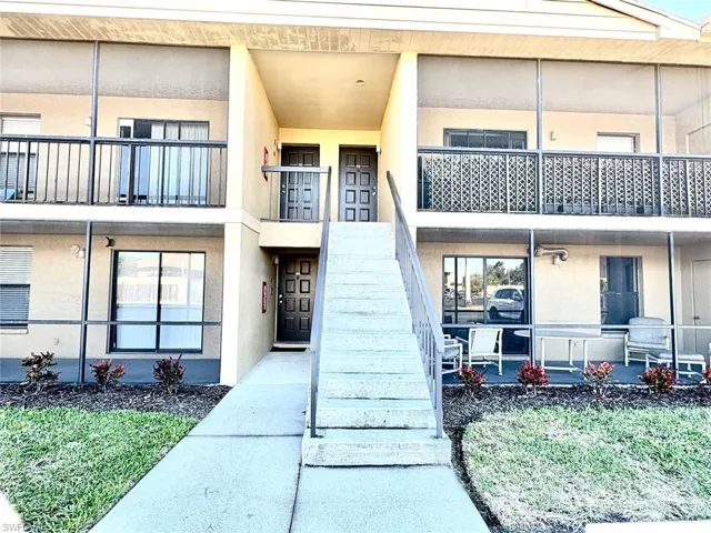 View of property with stairs