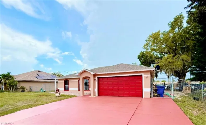 Ranch-style home with a garage, stucco siding, and driveway