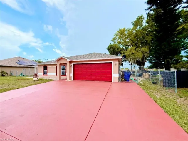 Ranch-style home featuring stucco siding, a garage, and concrete driveway