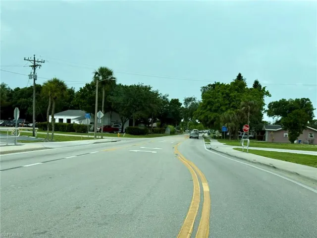 View of asphalt road with traffic signs