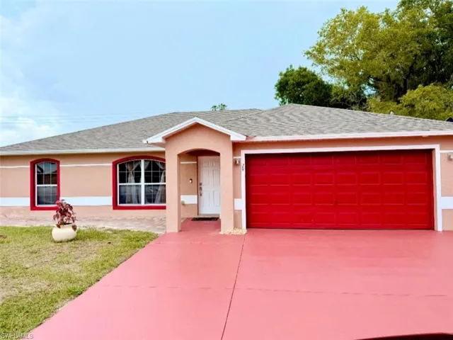 Ranch-style house featuring stucco siding, a garage, concrete driveway, and roof with shingles