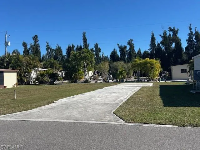 View of home's community with a yard