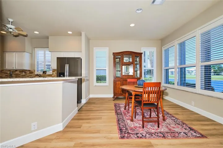 Dining area with a ceiling fan, light wood-style flooring, recessed lighting, and baseboards