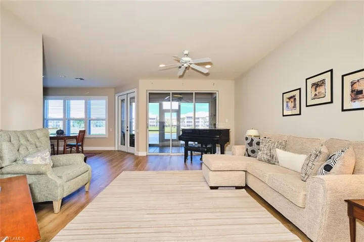 Living room featuring wood finished floors, ceiling fan, and baseboards
