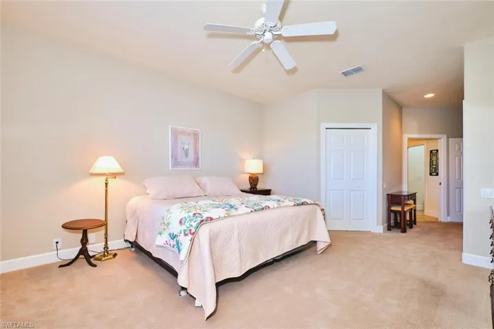 Bedroom with light carpet, baseboards, a closet, recessed lighting, and a ceiling fan