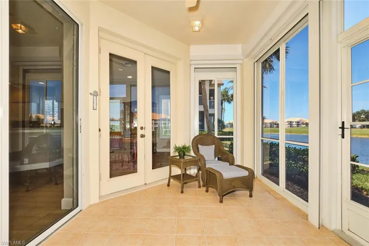 Sunroom / solarium with french doors, tile patterned flooring, and healthy amount of natural light