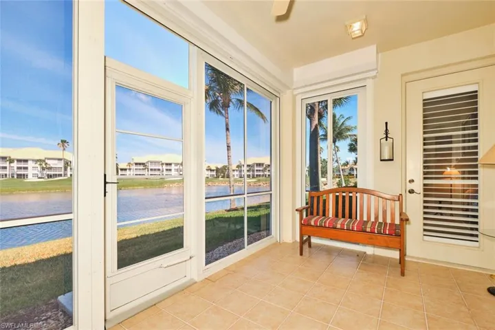 Sunroom featuring a water view and tile patterned flooring