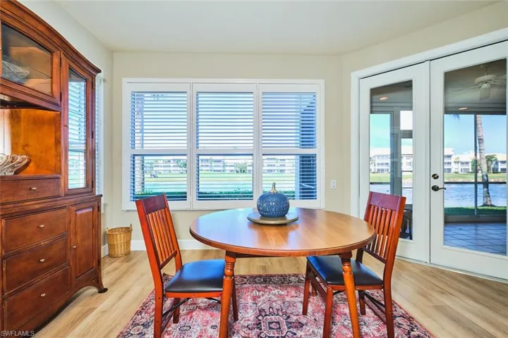 Dining room with french doors, light wood-style flooring, and plenty of natural light