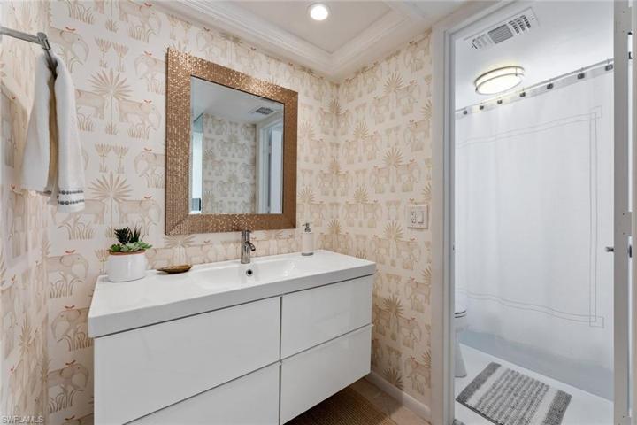Guest Bathroom with fun new trendy wallpaper. Just enough pop of color around the floating vanity.