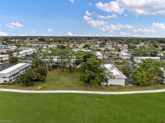Arial view of the private landscaped parklike setting. Condo nestled behind the trees in the center of the photo.