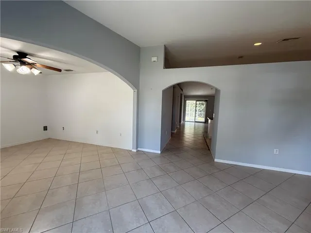 Tiled spare room with ceiling fan