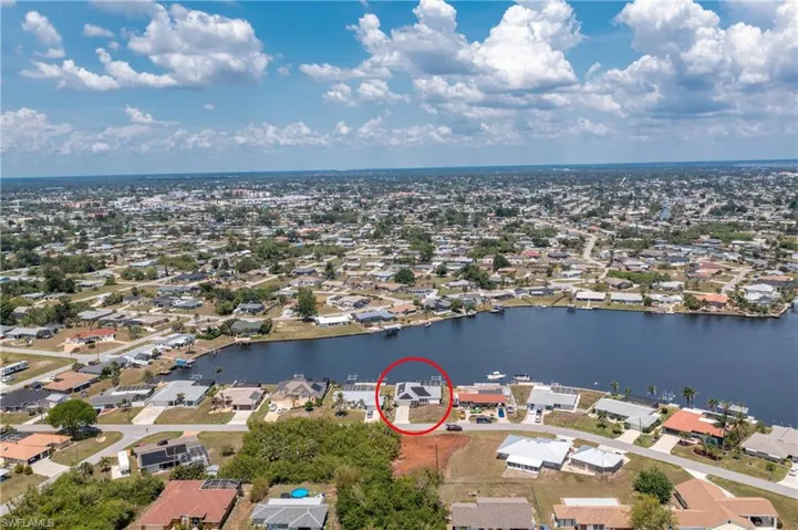 Aerial view of residential area featuring a large body of water