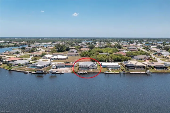 Aerial perspective of suburban area with a nearby body of water