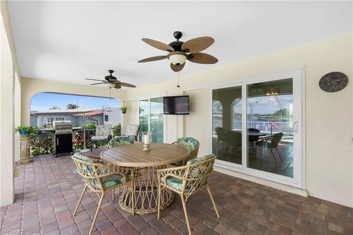 View of patio / terrace with ceiling fan, a grill, and outdoor dining space