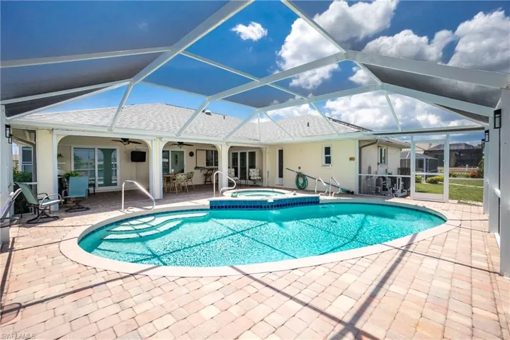 Swimming pool featuring an in-ground hot tub, ceiling fan, a patio area, and a lanai