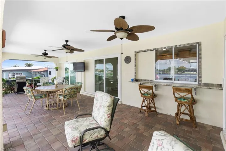View of patio / terrace featuring ceiling fan, outdoor dining space, and exterior kitchen
