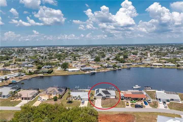 Aerial perspective of suburban area with a nearby body of water