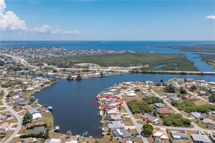 Aerial perspective of suburban area with a nearby body of water