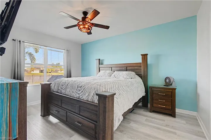 Bedroom with light wood-style flooring and a ceiling fan