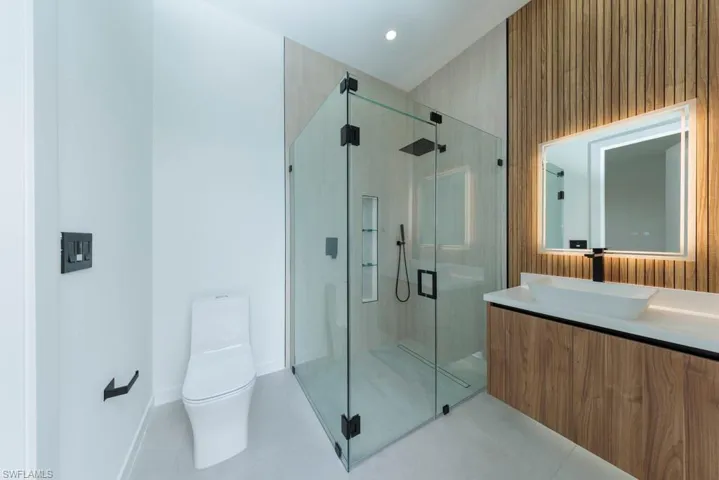 Bathroom featuring vanity, a stall shower, and tile patterned floors