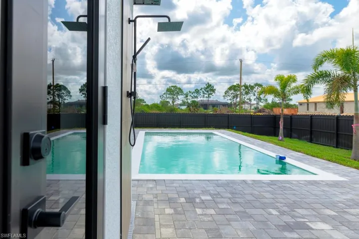 View of swimming pool featuring a fenced backyard and a patio area
