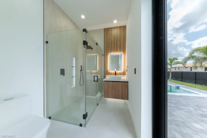 Full bathroom with vanity, a shower stall, and recessed lighting