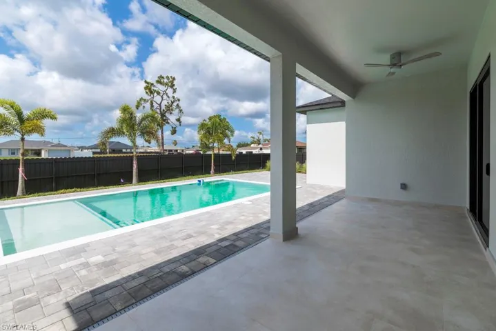 View of pool featuring a ceiling fan, a fenced backyard, and a patio