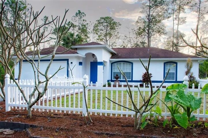 View of front of home featuring a garage and a front yard