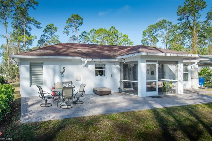 Rear view of house featuring a patio area and a sunroom