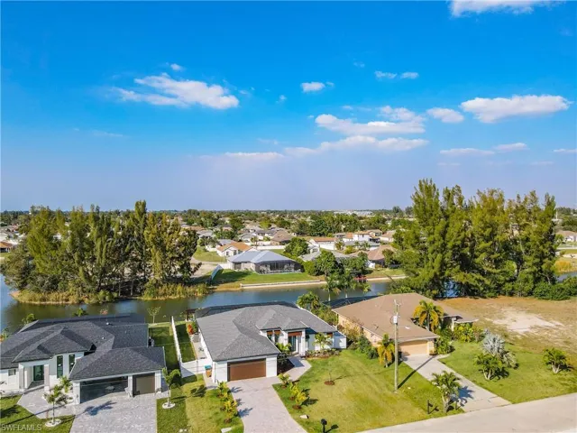 Aerial perspective of suburban area featuring a large body of water