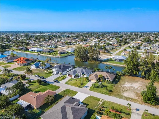 Aerial view of property's location featuring a large body of water and nearby suburban area