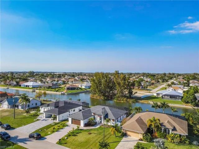 Aerial perspective of suburban area featuring a nearby body of water