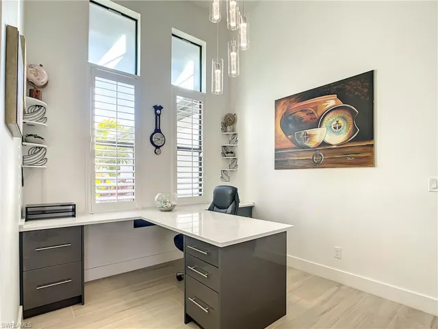 Office area featuring light wood-style flooring and baseboards