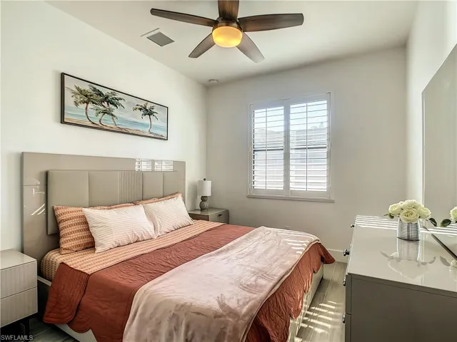 Bedroom with wood finished floors and ceiling fan