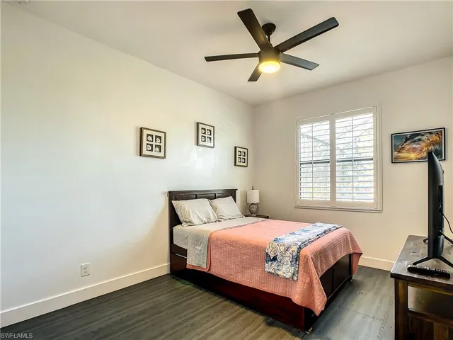 Bedroom with wood finished floors and ceiling fan