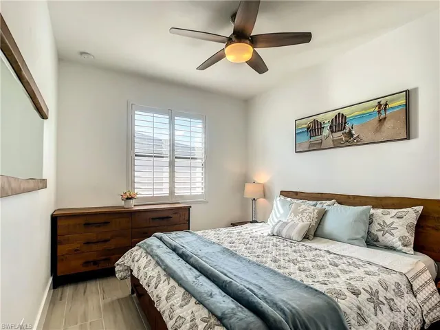 Bedroom with ceiling fan and wood finished floors