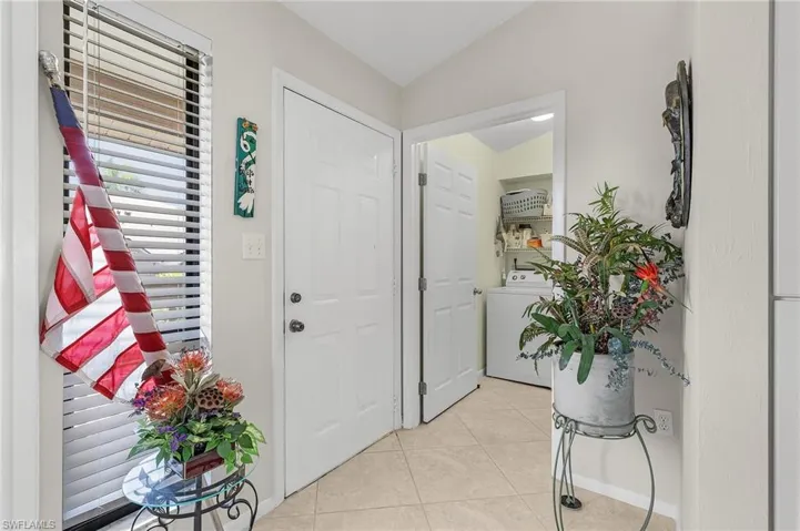 Entrance foyer featuring light tile flooring, and vaulted ceiling