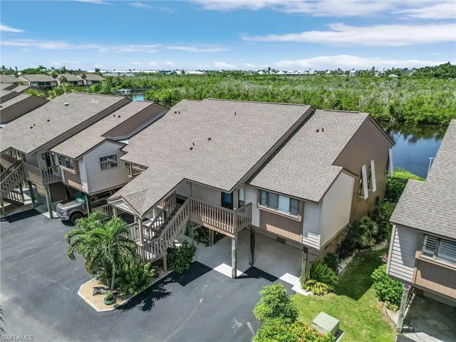 Birds eye view of property with a water view