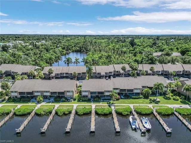 Birds eye view of property with a water view